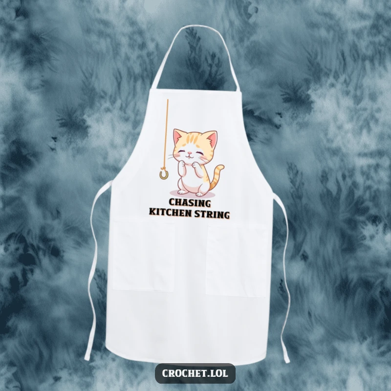 Funny apron showcasing a tiny, curious cat playing with yarn and a hook, ideal for kitchen or craft protection with a feline flair.