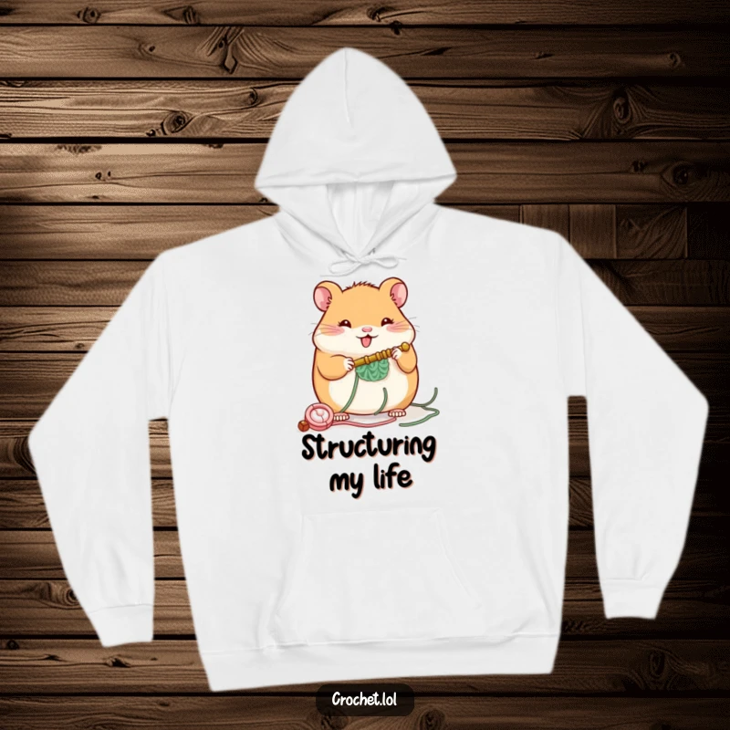 Funny hoodie featuring a plump, cheerful hamster with a crochet hook, building a small structure, designed for ultimate comfort and fun.