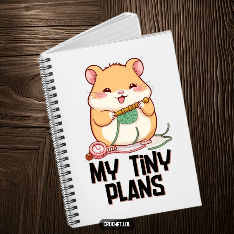 Funny notebook cover featuring a plump, cheerful hamster with a crochet hook, building a small structure, designed to inspire creativity.